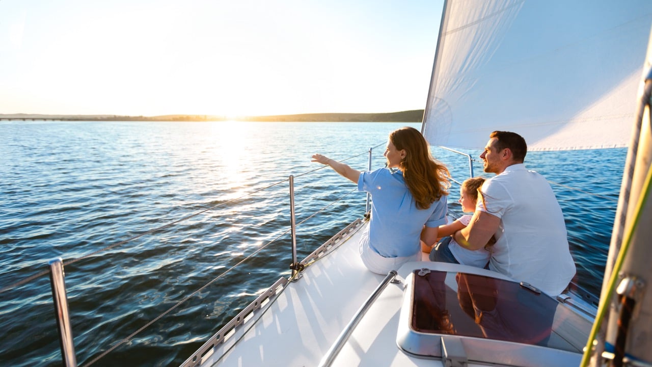 family-sitting-on-yacht-deck-sailing-across-the-se-2022-12-16-09-24-20-utc Large